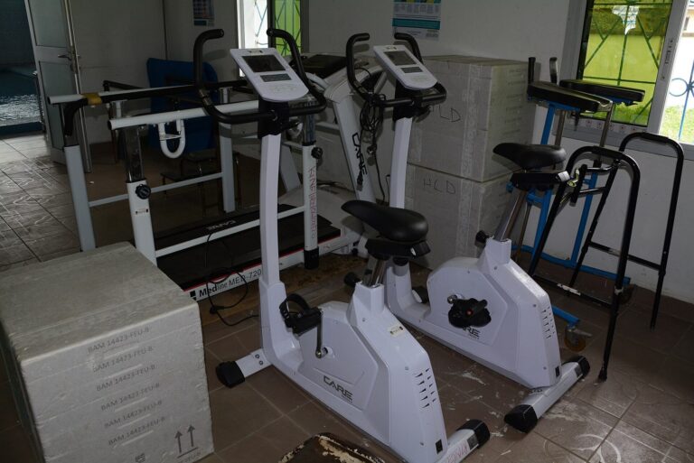 Appareils de reeducation dans un cabinet de kinesitherapie : velos ergometres, tapis de marche et barres paralleles
